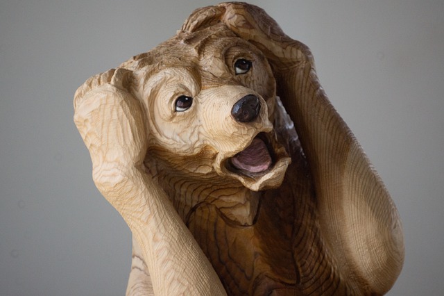 頭を抱える木彫りの熊